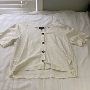 Cream colored short sleeve shirt
